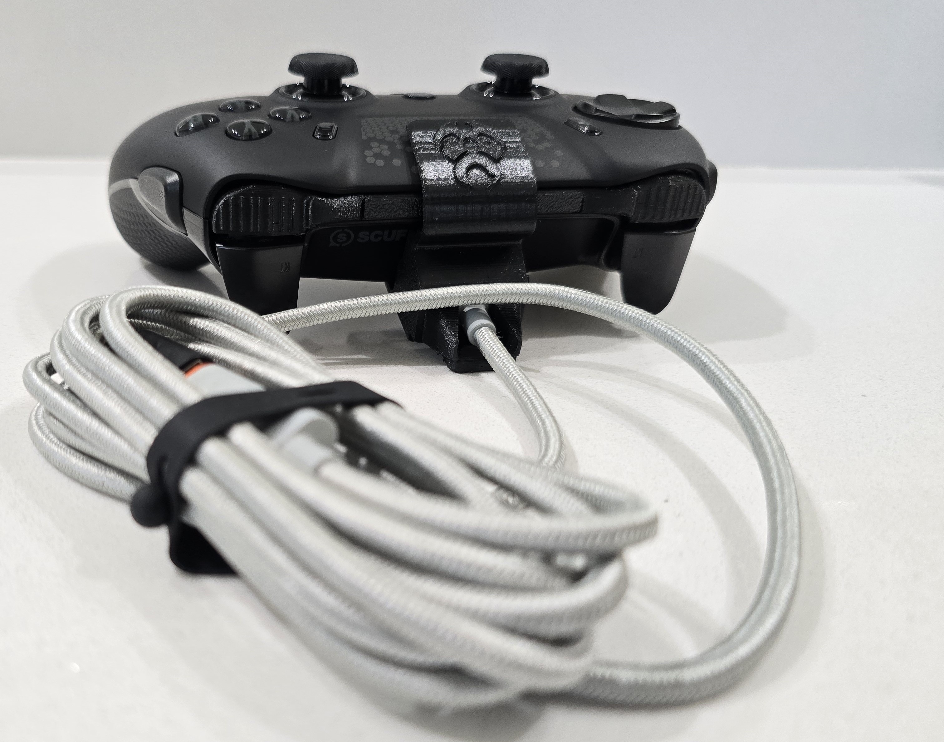 A demonstration of the accessory installed on the controller, showing how it supports a more secure wired connection.