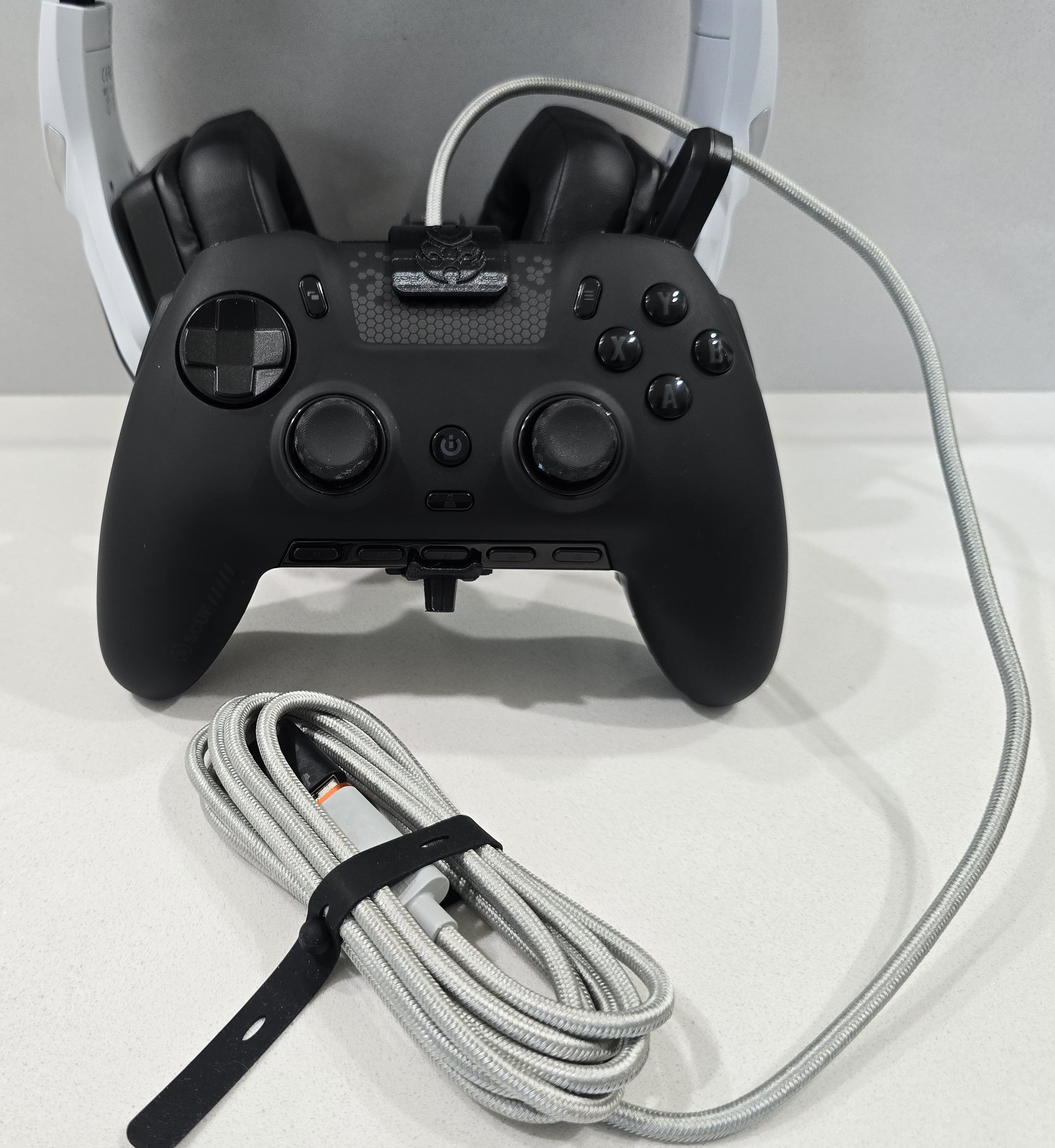This image shows CORDARMOUR fitted onto a SCUF Envision controller to help stabilize the USB-C cable and protect the port.